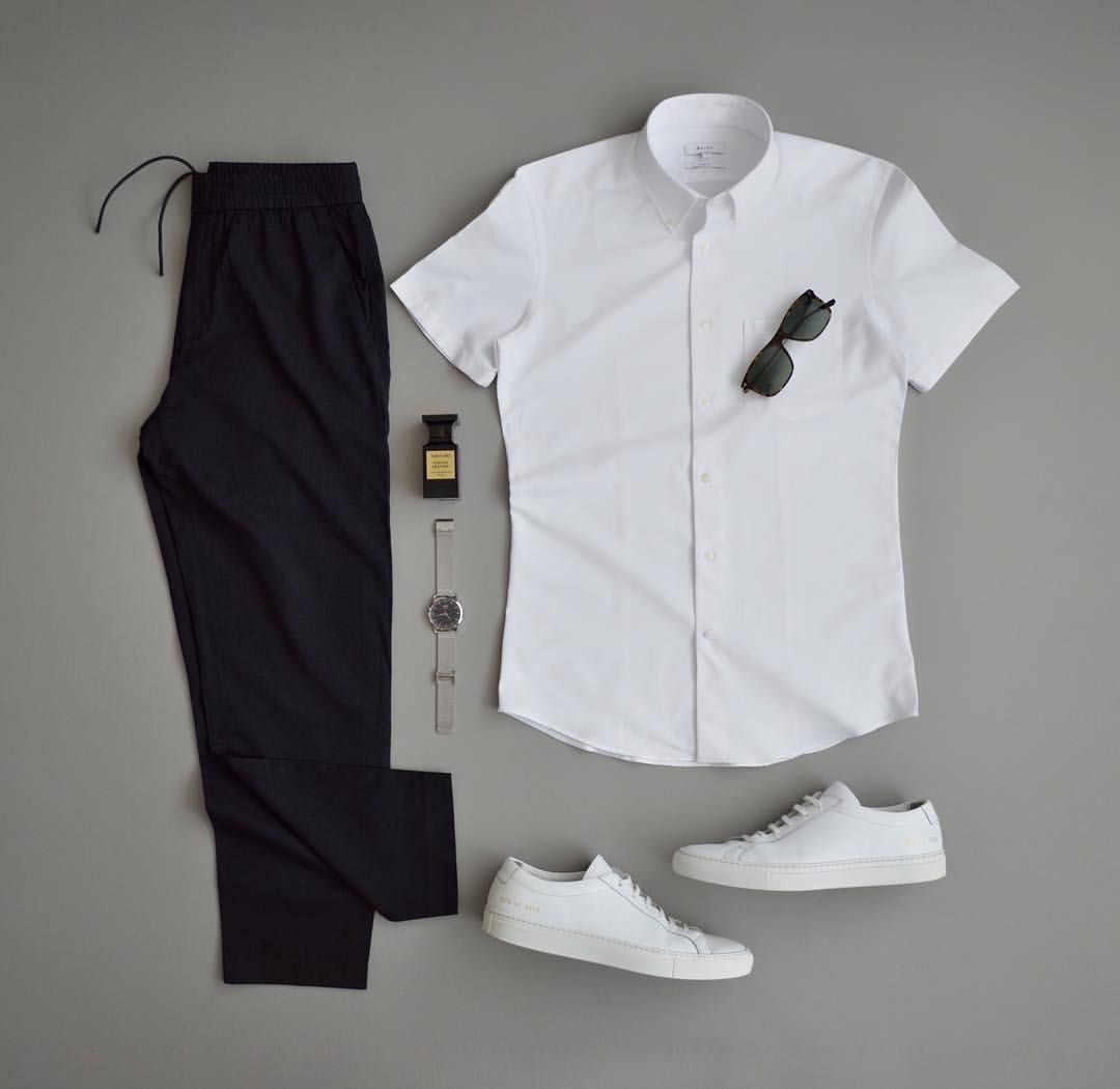 Style reference: a white short-sleeve shirt, black trousers and white trainers arranged flat