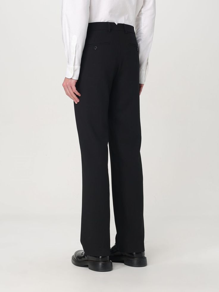 Style reference: the back of black tailored trousers worn with a white shirt